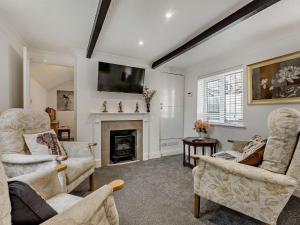 a living room with two chairs and a fireplace at 3 Bed in Bognor Regis 93447 in Bognor Regis