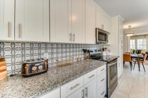 a kitchen with white cabinets and a toaster on a counter at Elizabeth City Abode with Fenced Yard, Near Downtown in Elizabeth City