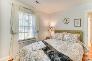 a bedroom with a bed and a window at Elizabeth City Abode with Fenced Yard, Near Downtown in Elizabeth City