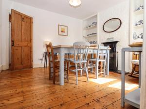 a dining room with a table and chairs at Fishermans Cottage in Whitstable