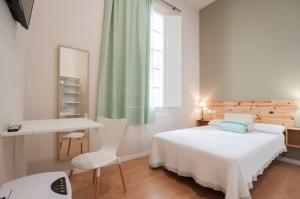Triana 103 Rooms & Suites客房内的一张或多张床位