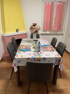 a dining room table with a colorful table cloth on it at B&B Cloè in Pregassona