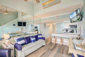 a living room with a couch and a table at Sugar Beach 301 by Vacation Homes Collection in Gulf Shores +33 photos