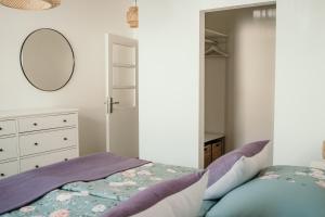 a bedroom with a bed and a mirror at Haus42 in Illmitz