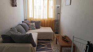 a living room with a couch and a table at ARMIRA HOME in Kalymnos