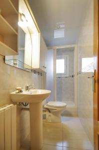 a bathroom with a sink and a toilet and a mirror at Matarolux 2 in Mataró +18 photos