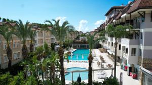 a view from the balcony of a hotel with palm trees at Side Village Family Suite - All Inclusive in Side