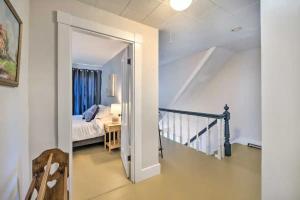 a hallway leading to a bedroom with a bed at New! Charming Bingham Home Near Outdoor Adventure! in Bingham