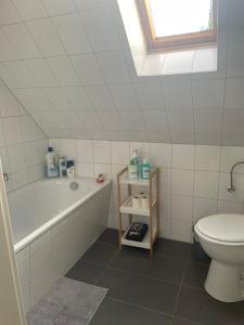 a bathroom with a tub and a toilet and a sink at Familie Alber 2P in Elze
