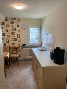 a kitchen with a counter and a table and a window at Familie Alber 2P in Elze