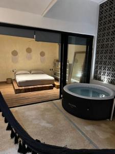 een grote slaapkamer met een bad en een bed bij Penthouse kavali in Los Ayala