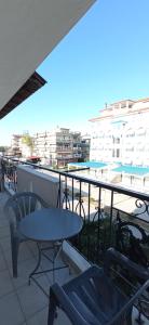 a patio with a table and chairs on a balcony at Sunrise2 in Paralia Katerinis