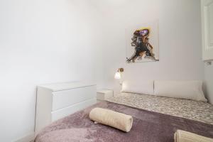 a bedroom with a bed with a pillow on it at Carrer de Santa Madrona, 1 in Barcelona