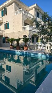 a house with a swimming pool in front of it at Villa Chantal in Kotor