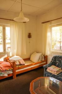 a living room with a bed and a couch at Gospodarstwo Agroturystyczne Kłączno in Kłaczno