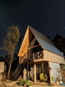 a large house with a gambrel roof with a staircase at Eco house sunset in K'obulet'i