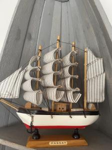 un modelo de barco en un puesto de madera en Strandperle 2 - a78241, en Loissin