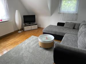 a living room with a couch and a coffee table at Ferienwohnung Emily in Friesenheim