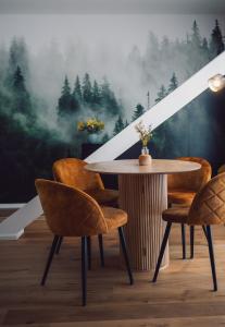 a table and chairs in front of a forest mural at Suite 13 im Wald mit Balkon in Amberg