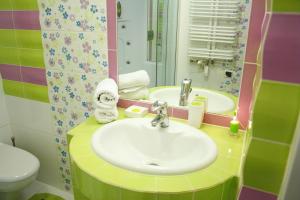 a bathroom with a sink and a toilet and a mirror at Domek w Górach - Przy Potoku in Zakopane +36 photos