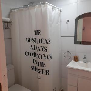 a bathroom with a shower curtain with the words at Espacio Los Ciruelos Ituzaingo in Ituzaingó