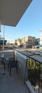 a balcony with a table and chairs on a building at Sunrise1 in Paralia Katerinis +13 photos