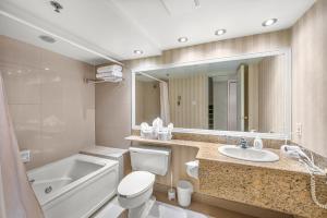 a bathroom with a tub and a toilet and a sink at Le Bordeau à Saint-Sauveur in Saint-Sauveur-des-Monts +97 photos