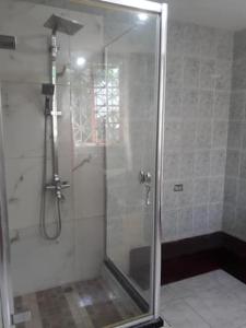 a shower with a glass door in a bathroom at Comfort rooms in Content