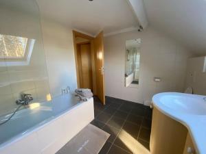 a bathroom with a sink and a tub and a toilet at La réserve by la Villa KerKus in Fraipont +24 photos