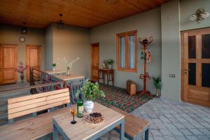 a patio with two benches and a table and a door at Hotel Tsinandali Memories in Tsinandali