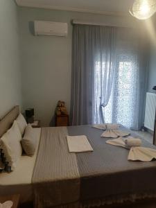 a bedroom with a large bed with towels on it at POPI 'S HOME in Skala Sotiros