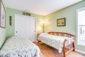 a bedroom with two beds next to a door at Near Beaches and Shops Canal-Front Selbyville Home in Selbyville