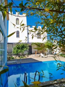 a view of the house from the garden at Laguna Villa - Pool, Sauna, Events - at Bazaleti Lake in Karsimaantkari