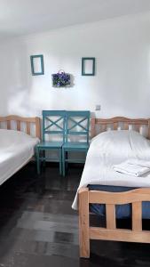 a bedroom with two beds and two tables in it at Femyli rooms in Shekvetili