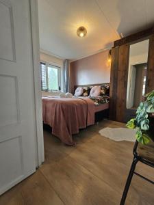 a bedroom with a bed and a window at Tip Top Studio Vlissingen in Vlissingen