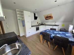 a kitchen and dining room with a table and chairs at Warendorf 12 in Warendorf