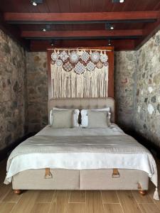 a bedroom with a bed with plates on the wall at Villa Di Mare Bodrum in Bodrum City