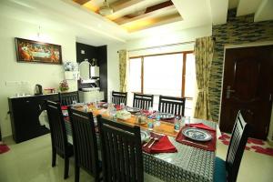 a dining room with a table and chairs in a kitchen at Captains Cabin backwater resort in Alleppey