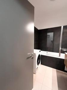 a white washing machine in a bathroom with a mirror at 2 Șic rooms Park Copou AB Homes in Iaşi
