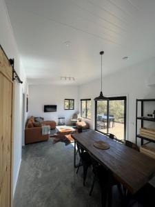 a living room with a table and a couch at Hygge Eco Cabins in Jindabyne