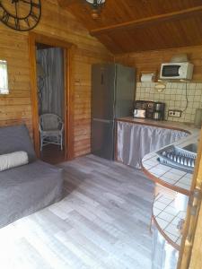 a living room with a couch and a refrigerator at Chalet Dominique 