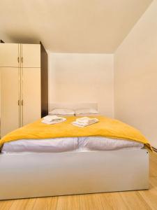 a bedroom with a bed with two towels on it at Old Town Bistrik - Free parking in Sarajevo