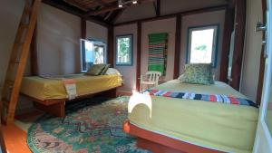 a bedroom with two beds in a room at La Esperanza Lodge and Reserve in Jardin