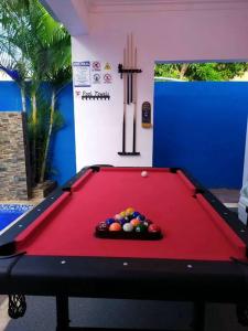 a red pool table with a pile of balls on it at LaPileta809 in La Romana
