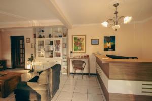 a living room with a counter and a chair at Pousada Café in Torres