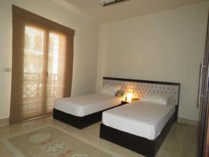 A bed or beds in a room at Azzurra two-Bedroom Apartment at Sahl Hasheesh