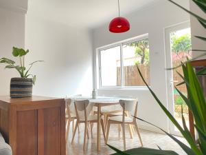 a dining room with a table and chairs at Terrace House in Lisbon