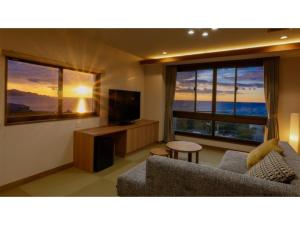 a living room with a couch and a television at KAISYU - Vacation STAY 42706v in Kyotango