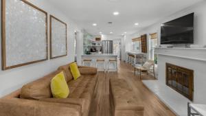 a living room with a couch and a fireplace at Grayt Fun in Santa Rosa Beach