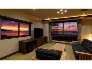a living room with two couches and a flat screen tv at KAISYU - Vacation STAY 42700v in Kyotango